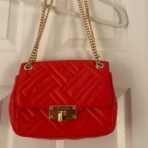 Burnt orange Michael Kors quilted purse with gold chain
